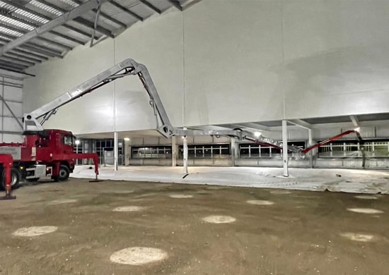 Wright Minimix boom pump delivering concrete indoors